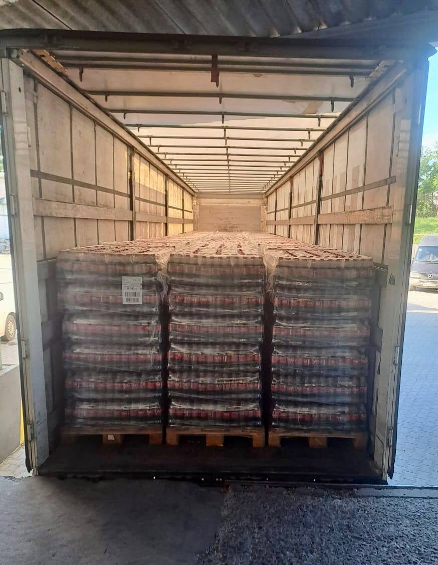 Three Coca-Cola can pallets semi-trailer rear view