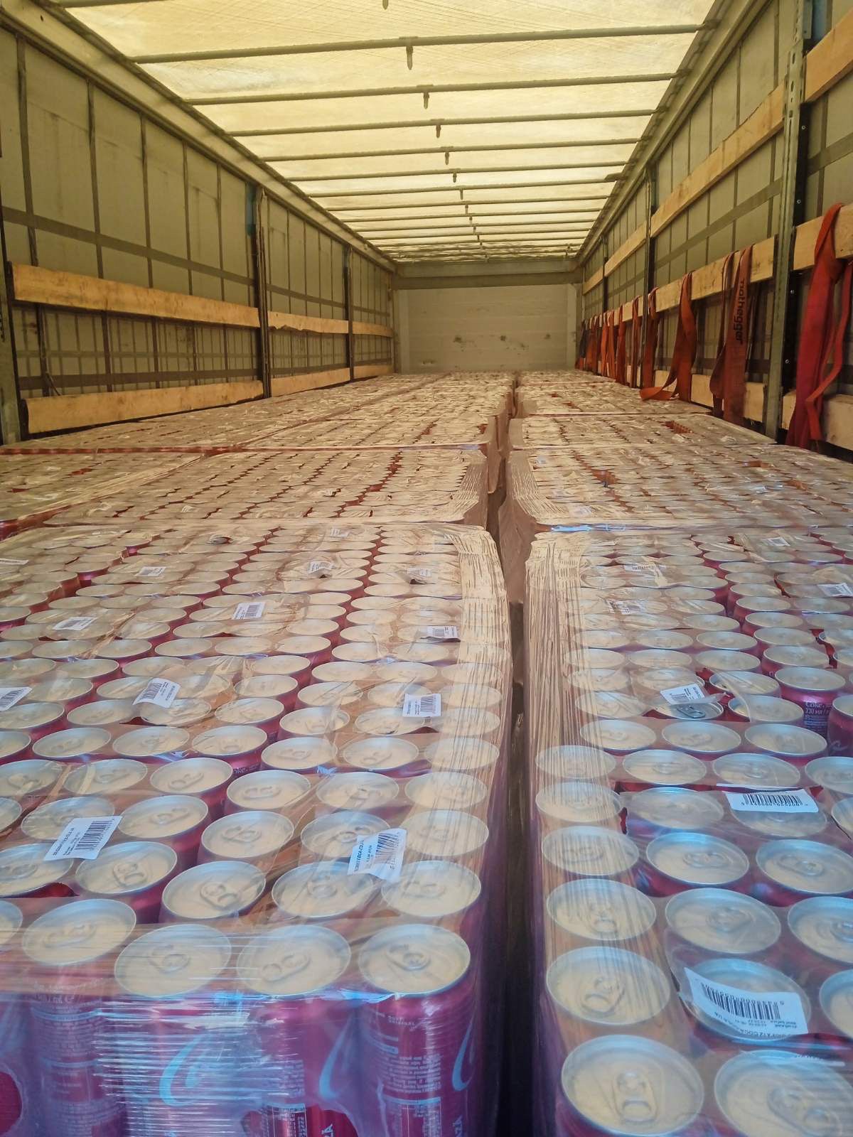 Trailer interior view full load Coca-Cola cans