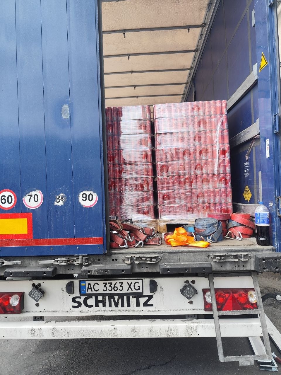 Securing straps and Coca-Cola pallets trailer back Schmitz
