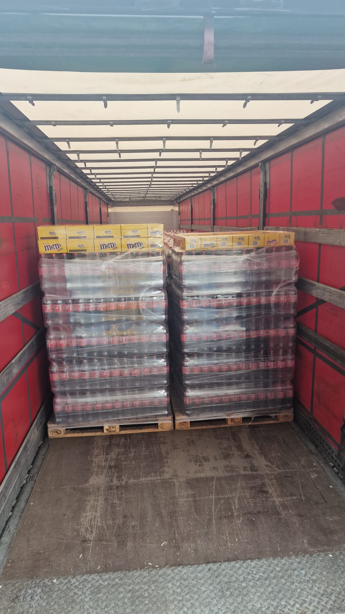 Two pallets Coca-Cola and M&M's overall trailer view